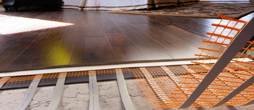 Heating mat installed below a timber floor